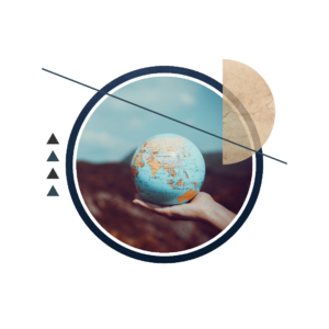 A hand holding a small globe above open ground