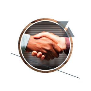 Two people shaking hands across a table